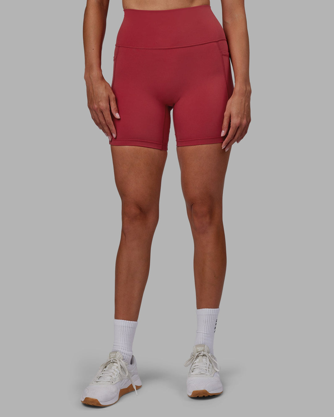 Woman wearing Fusion Ultra High-Rise 6&quot; Short Pockets - Claret | Model:Blaize | Size:S