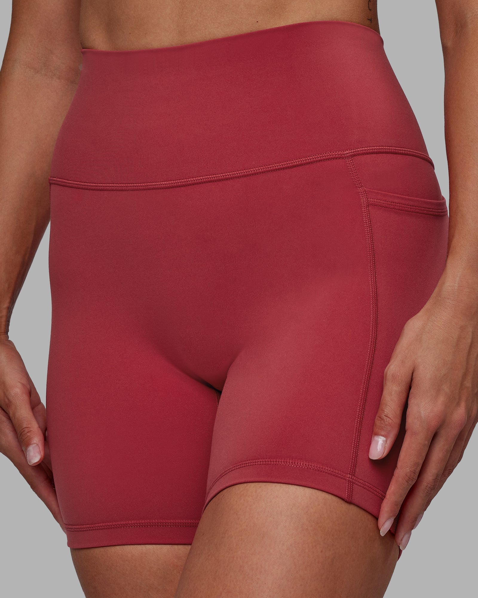 Woman wearing Fusion Ultra High-Rise 6" Short Pockets - Claret | Model:Blaize | Size:S