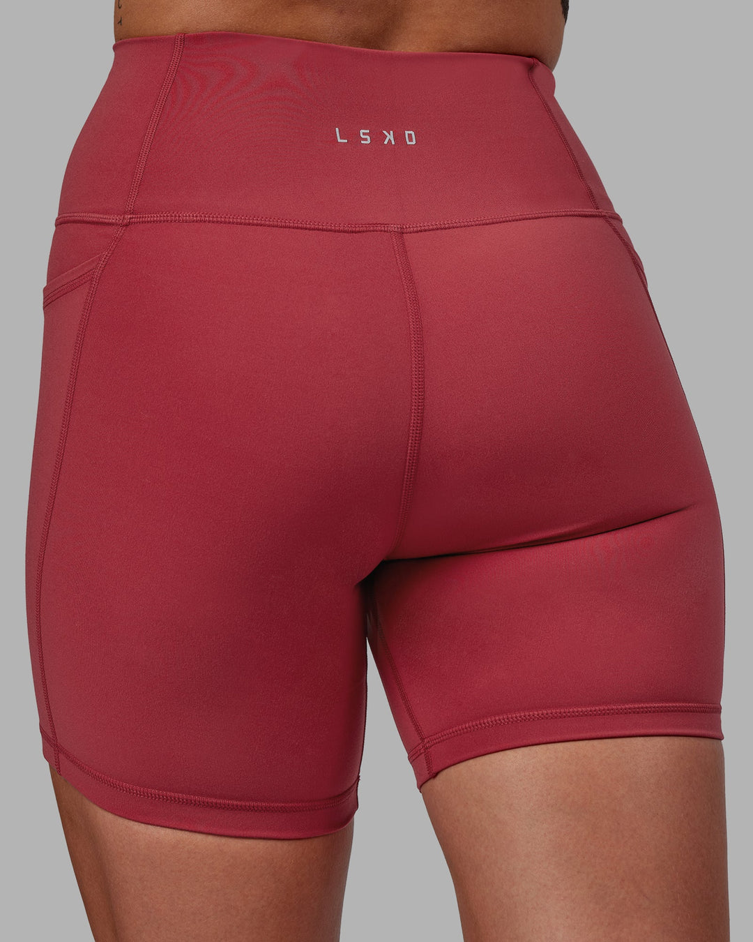 Woman wearing Fusion Ultra High-Rise 6&quot; Short Pockets - Claret | Model:Blaize | Size:S