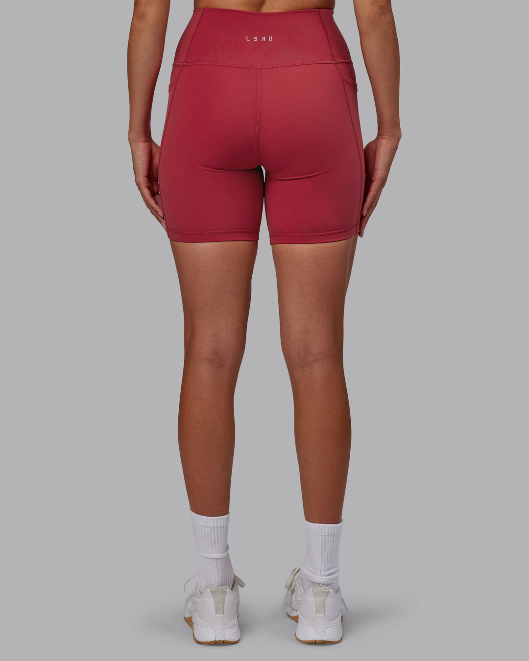 Woman wearing Fusion Ultra High-Rise 6&quot; Short Pockets - Claret | Model:Blaize | Size:S