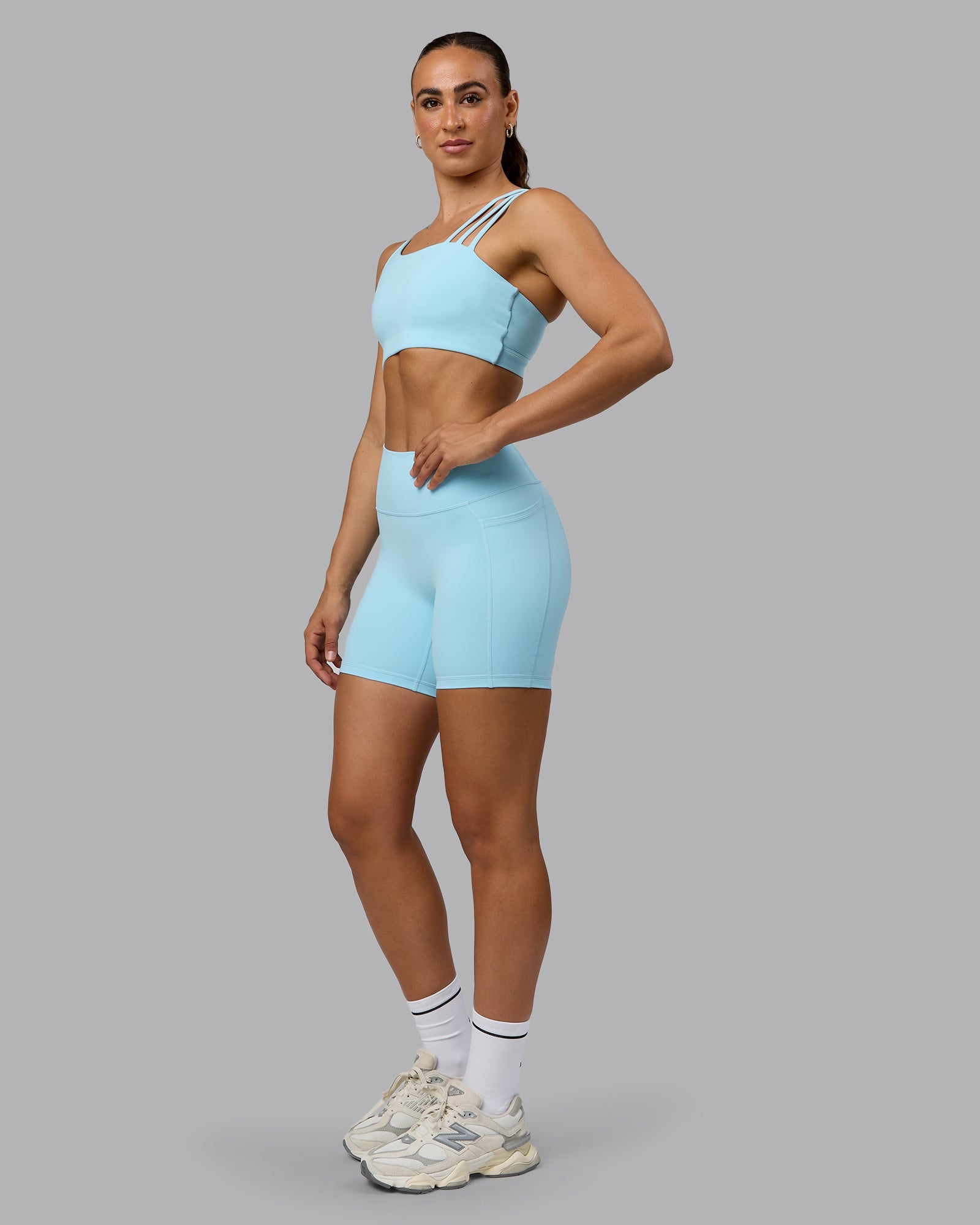 Woman wearing Fusion Ultra High-Rise 6" Short Pockets - Crystal Blue | Model:Sophie | Size:S