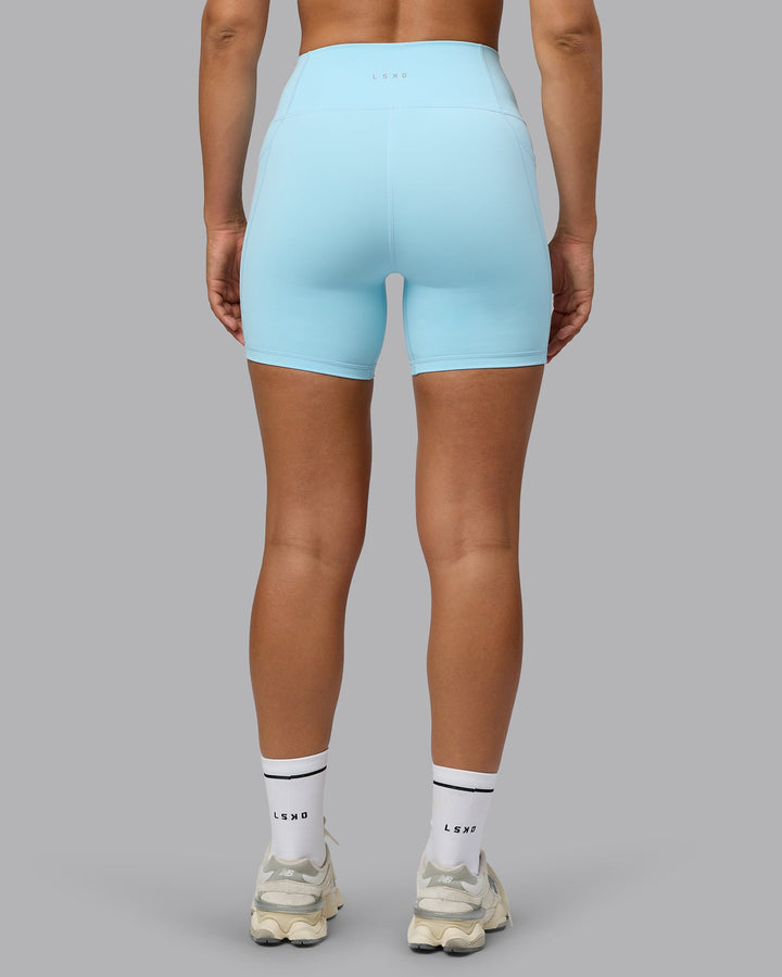 Woman wearing Fusion Mid Short Tights with Pockets - Crystal Blue
