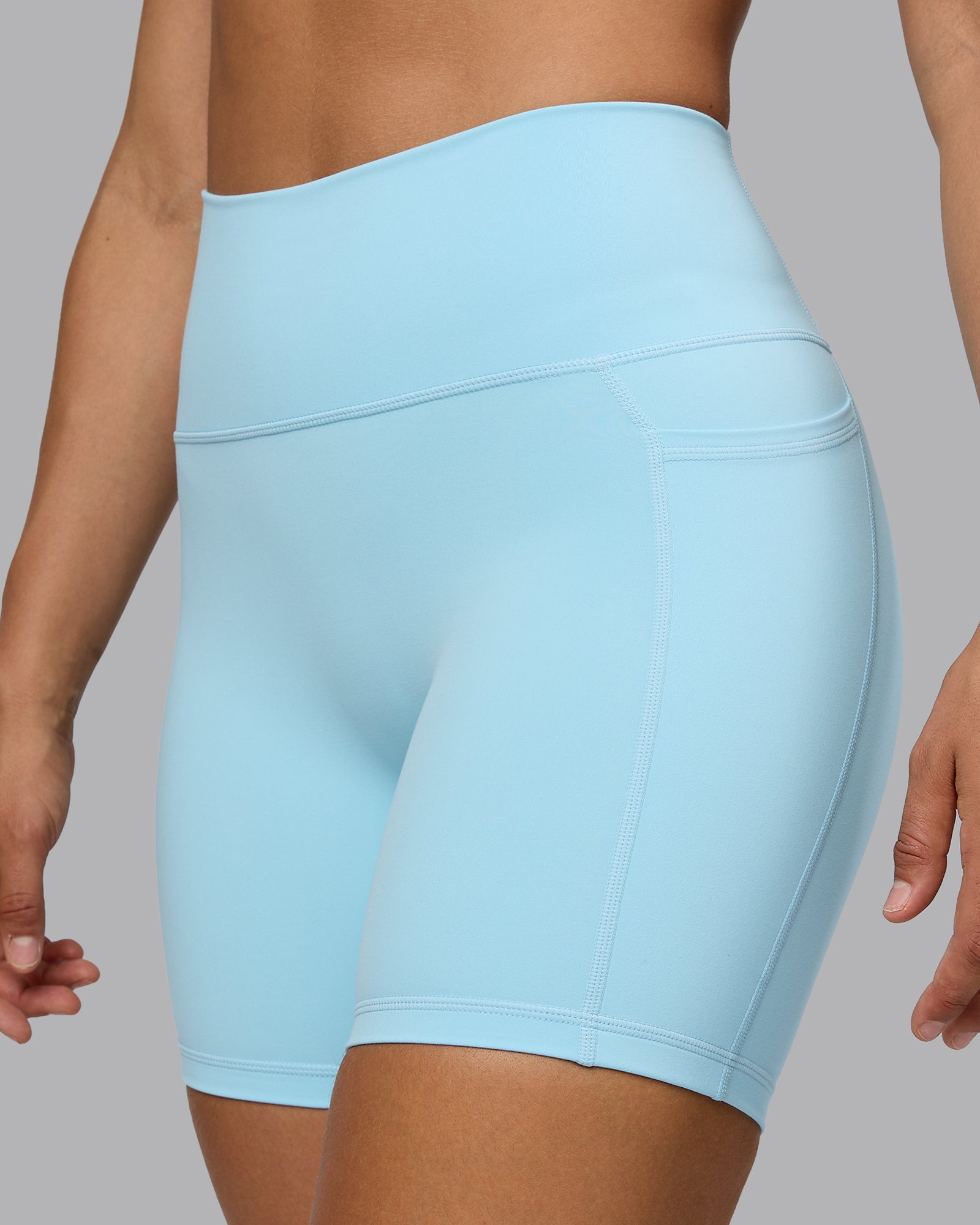 Woman wearing Fusion Ultra High-Rise 6" Short Pockets - Crystal Blue | Model:Sophie | Size:S