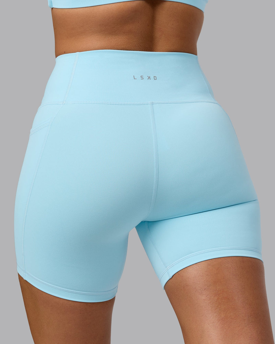 Woman wearing Fusion Mid Short Tights with Pockets - Crystal Blue