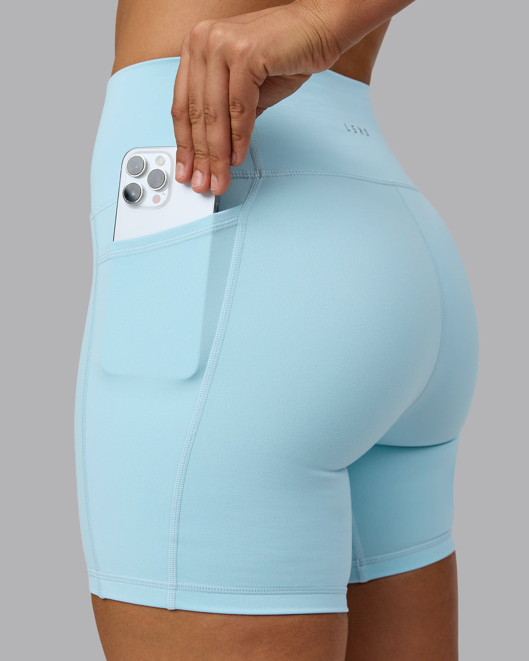 Woman wearing Fusion Mid Short Tights with Pockets - Crystal Blue