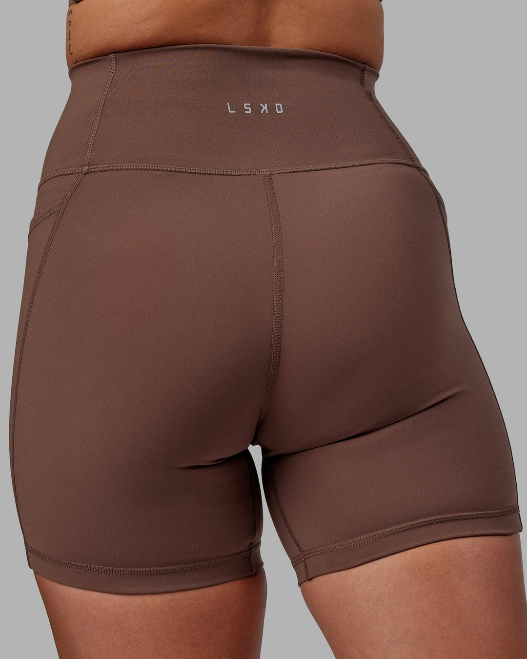 Woman wearing Fusion Mid-Length Shorts - Dull Rust