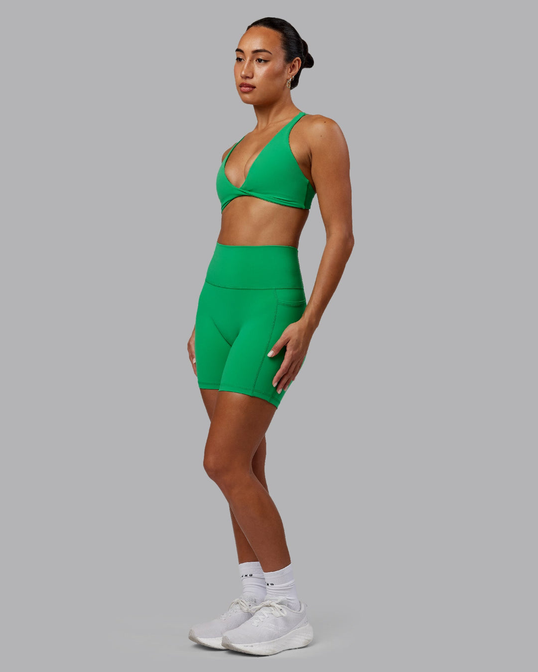 Woman wearing Fusion Ultra High-Rise 6&quot; Short Pockets - Impact Green | Model:Demi | Size:S