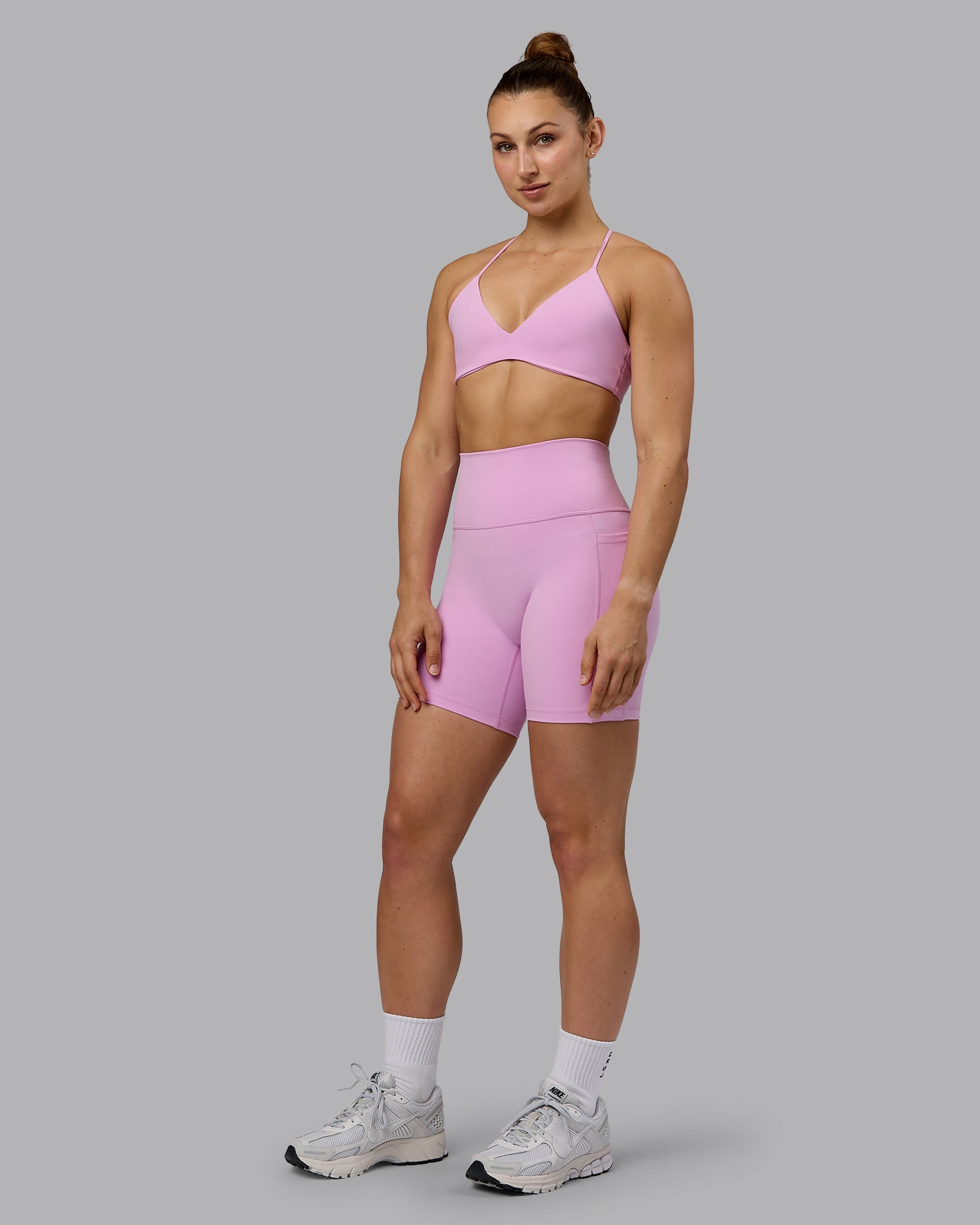 Woman wearing Fusion Ultra High-Rise 6" Short Pockets - Pastel Orchid | Model:Zoe | Size:S