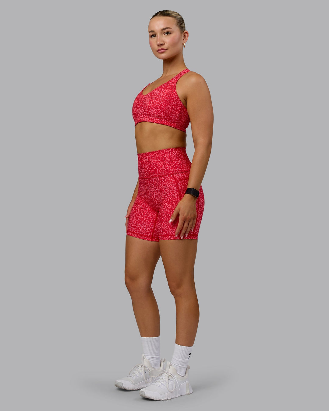 Woman wearing Fusion Ultra High-Rise 6&quot; Short Pockets - Red Vitality Print | Model:Halle | Size:S
