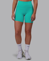 Woman wearing Fusion Ultra High-Rise 6" Short Pockets - Turquoise Tide | Model:Hannah | Size:S