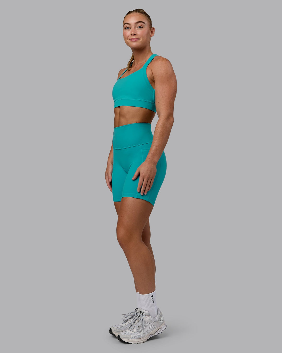 Woman wearing Fusion Mid Short Tights - Uplift Blue