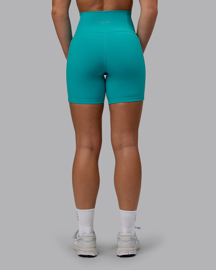 Woman wearing Fusion Mid Short Tights - Uplift Blue
