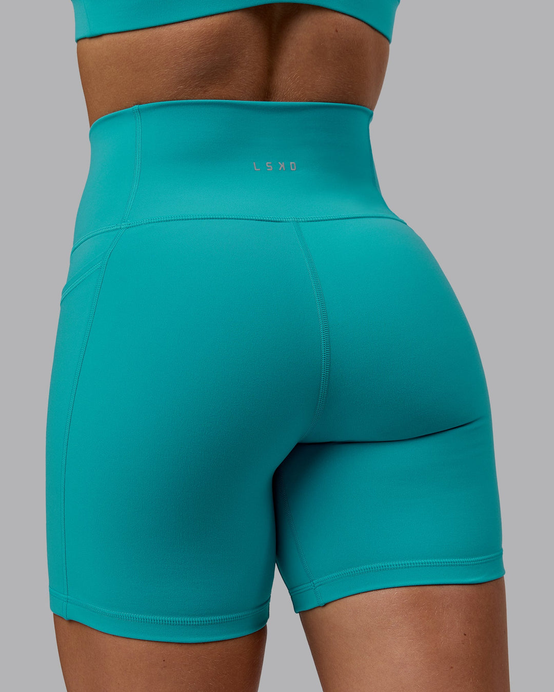 Woman wearing Fusion Mid Short Tights - Uplift Blue