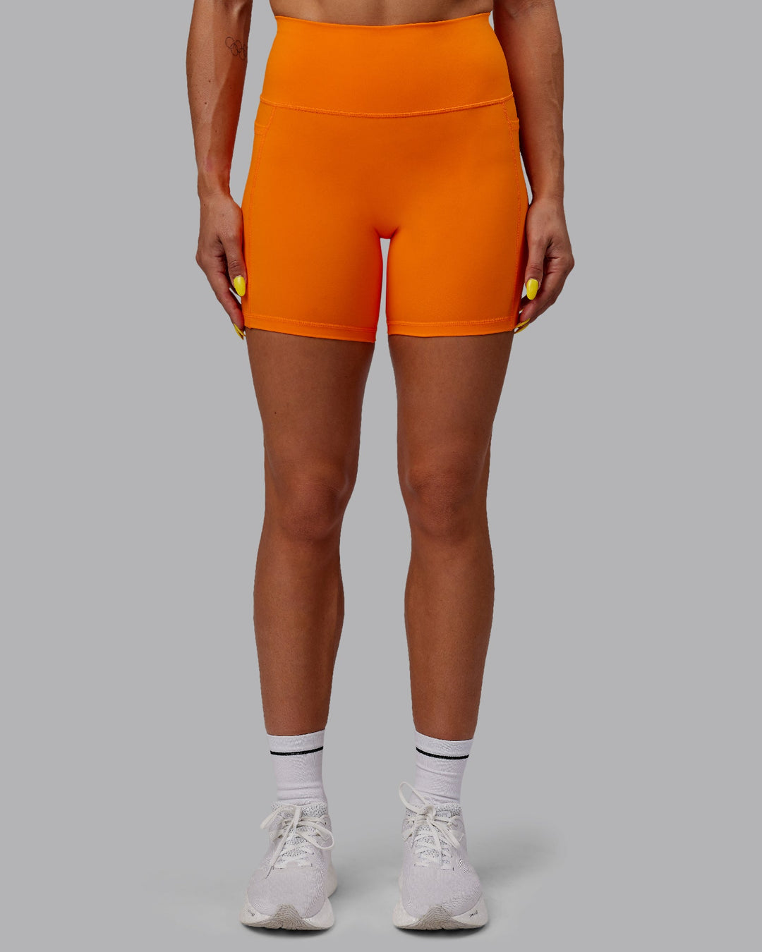 Woman wearing Fusion Ultra High-Rise 6&quot; Short Pockets - Vibrant Orange | Model:Bree | Size:S