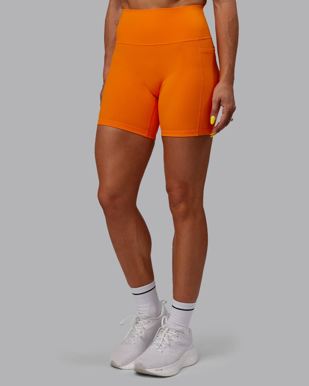 Woman wearing Fusion Ultra High-Rise 6&quot; Short Pockets - Vibrant Orange | Model:Bree | Size:S