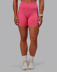 Woman wearing Fusion Ultra High-Rise 6" Short Pockets - Hot Pink | Set:true | Angle:front | Model:Amber | Size:S