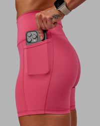 Woman wearing Fusion Ultra High-Rise 6" Short Pockets - Hot Pink | Set:true | Angle:closeup | Model:Amber | Size:S
