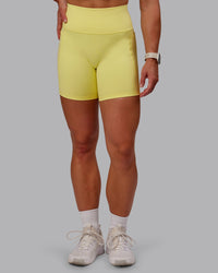 Woman wearing Fusion Ultra High-Rise 6" Short Pockets - Lemon Fizz | Set:true | Angle:front | Model:Amber | Size:S
