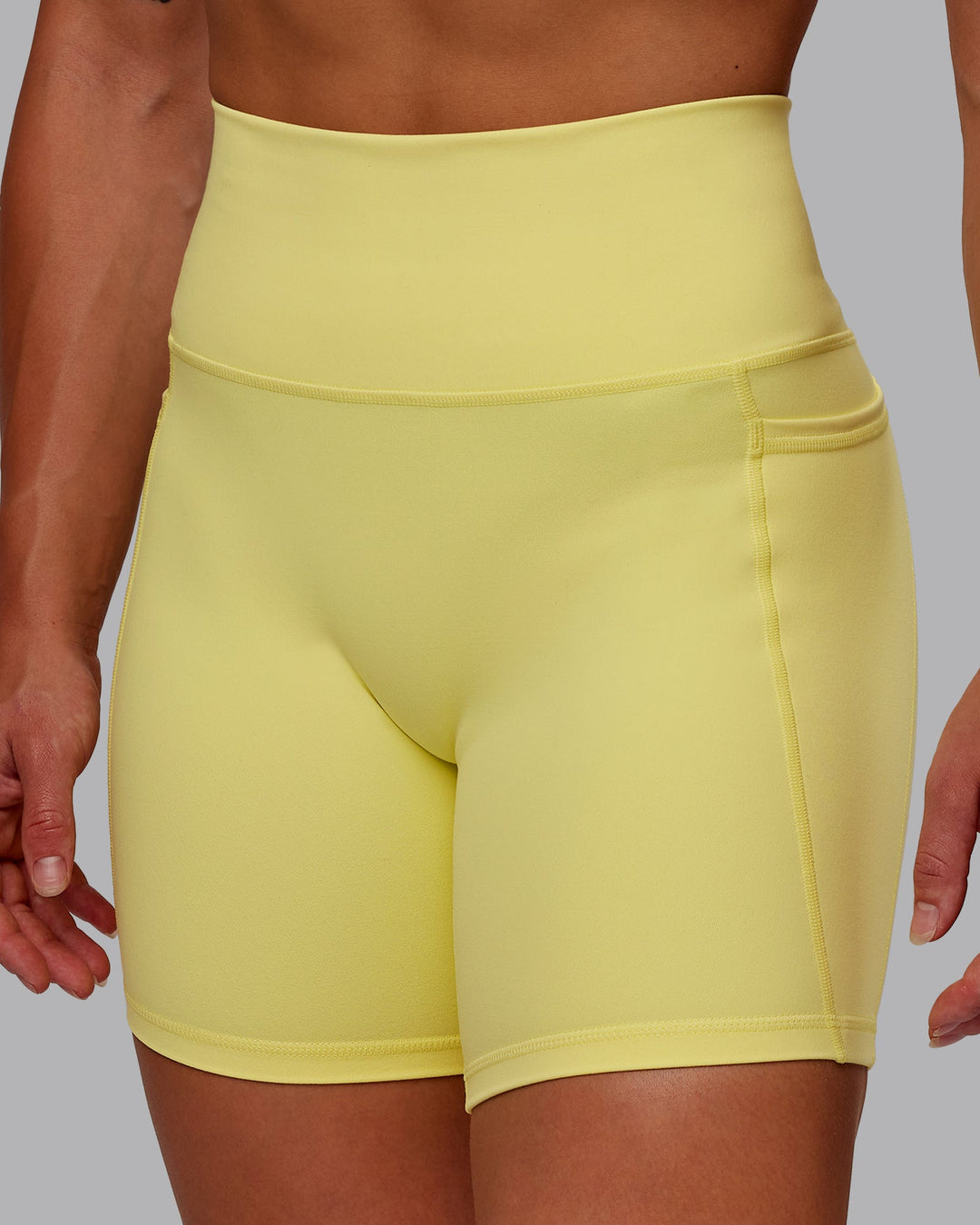 Woman wearing Fusion Mid Short Tight With Pockets - Lemon Fizz