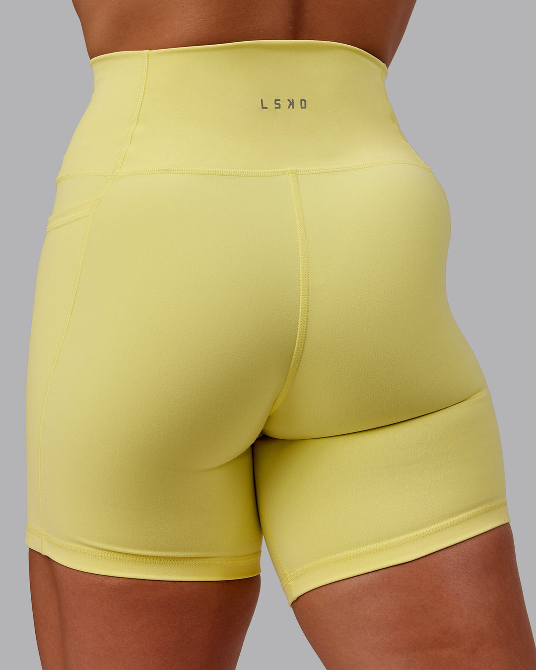 Woman wearing Fusion Mid Short Tight With Pockets - Lemon Fizz