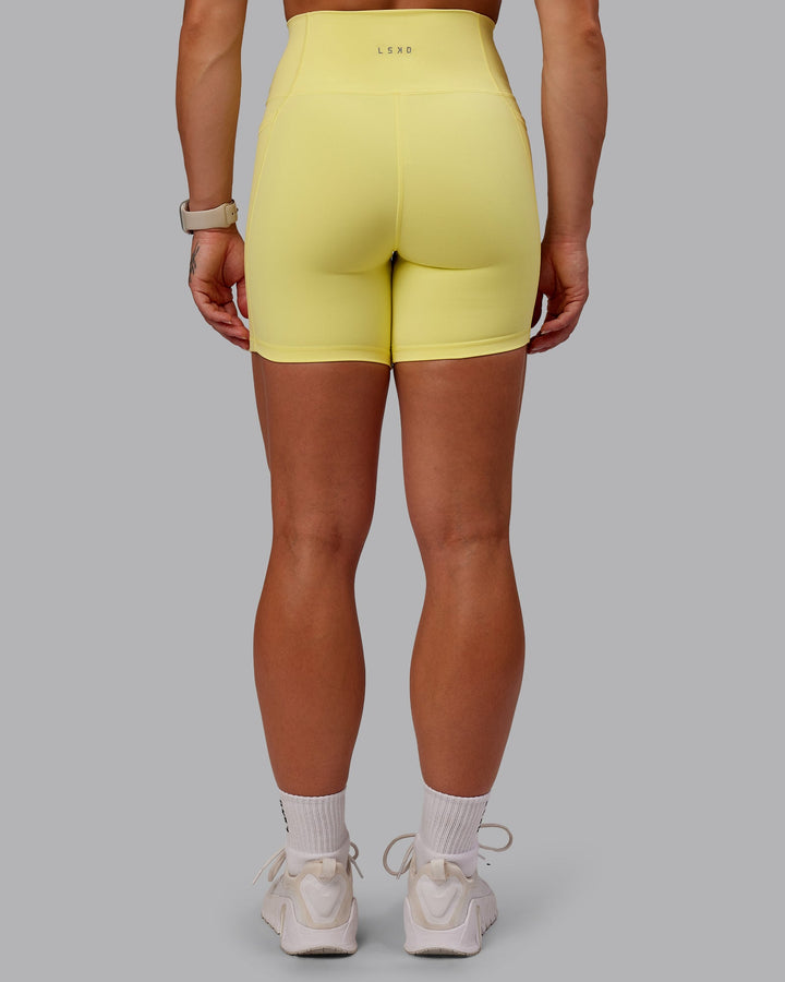 Woman wearing Fusion Mid Short Tight With Pockets - Lemon Fizz
