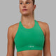 Woman wearing Fusion Sports Bra - Holly Green