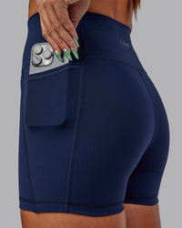 Woman wearing Fusion Ultra High-Rise 4" Short Pockets - Future Dusk | Model:Gabby | Size:S