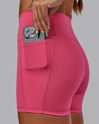 Woman wearing Fusion Ultra High-Rise 4" Short Pockets - Hot Pink | Set:true | Angle:closeup | Model:Vanessa | Size:S