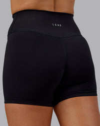 Woman wearing Fusion Ultra High-Rise 4" Short - Black | Model:Hannah | Size:S