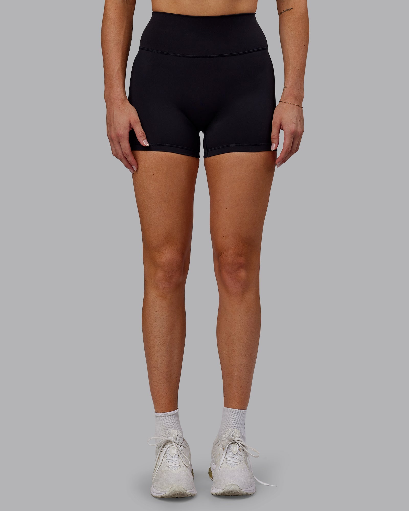 Woman wearing Fusion Ultra High-Rise 4" Short - Black | Model:Hannah | Size:S