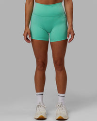 Woman wearing Fusion Ultra High-Rise 4" Short Pockets - Aquatic Awe | Model:Gabby | Size:S