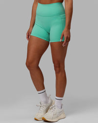 Woman wearing Fusion Ultra High-Rise 4" Short Pockets - Aquatic Awe | Model:Gabby | Size:S