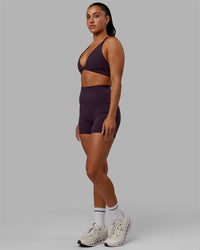 Woman wearing Fusion Ultra High-Rise 4" Short Pockets - Midnight Plum | Model:Gabby | Size:S