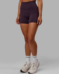 Woman wearing Fusion Ultra High-Rise 4" Short Pockets - Midnight Plum | Model:Gabby | Size:S