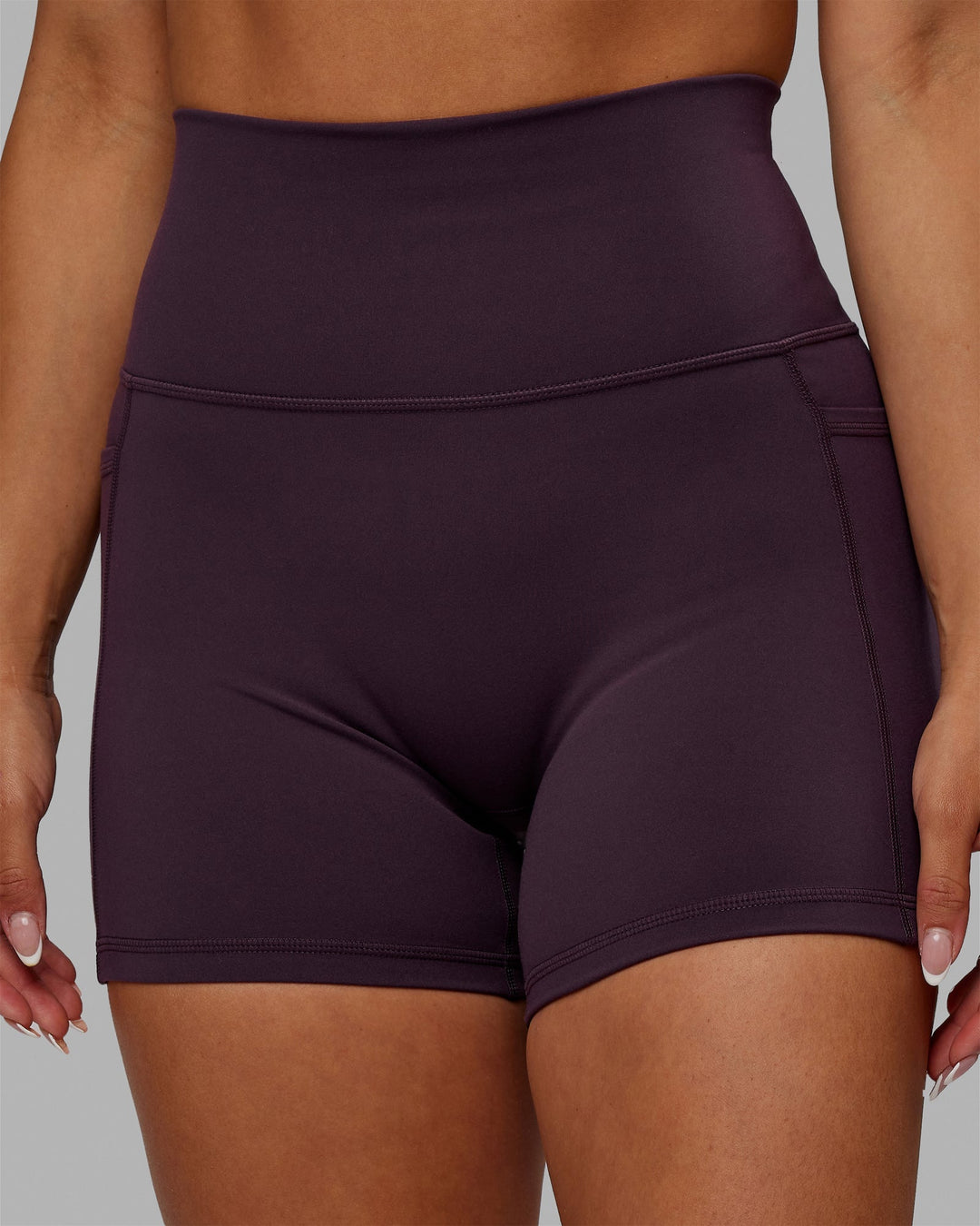 Woman wearing Fusion Ultra High-Rise 4" Short Pockets - Midnight Plum | Model:Gabby | Size:S