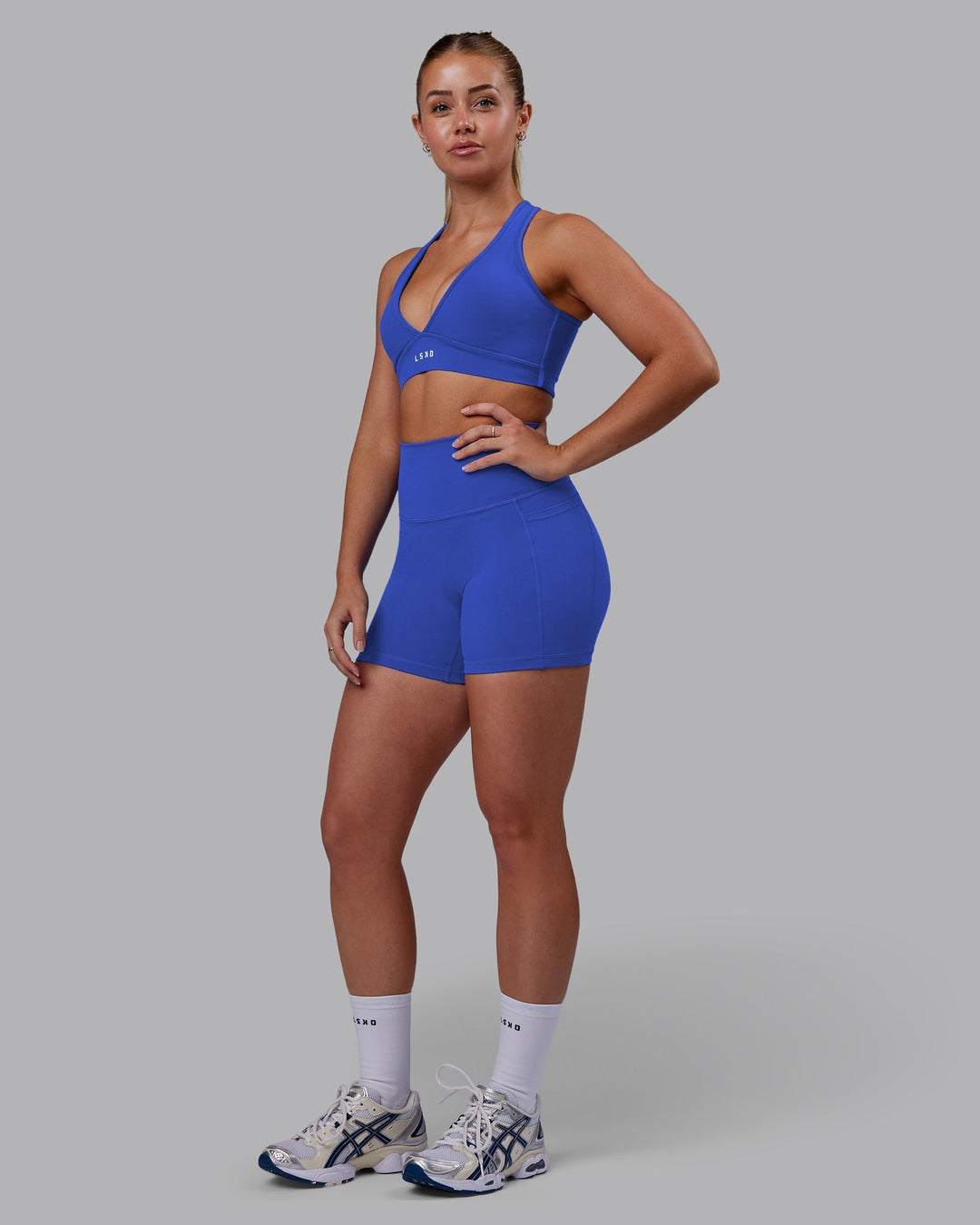 Woman wearing Fusion Ultra High-Rise 4" Short Pockets - Power Cobalt | Model:Hannah | Size:S