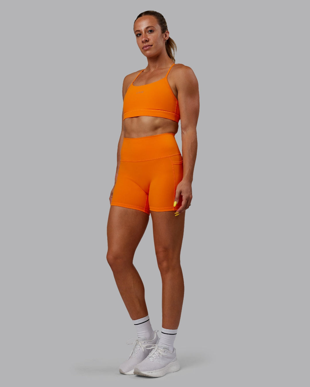 Woman wearing Fusion X-Length Shorts - Vibrant Orange