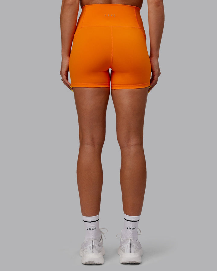 Woman wearing Fusion X-Length Shorts - Vibrant Orange
