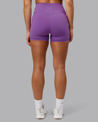 Woman wearing Fusion Ultra High-Rise 4" Short Pockets - Purple Fizz | Model:Shalem | Size:S