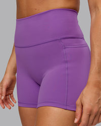 Woman wearing Fusion Ultra High-Rise 4" Short Pockets - Purple Fizz | Model:Shalem | Size:S