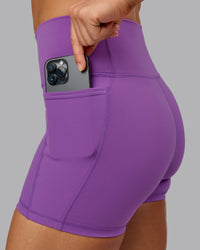 Woman wearing Fusion Ultra High-Rise 4" Short Pockets - Purple Fizz | Model:Shalem | Size:S