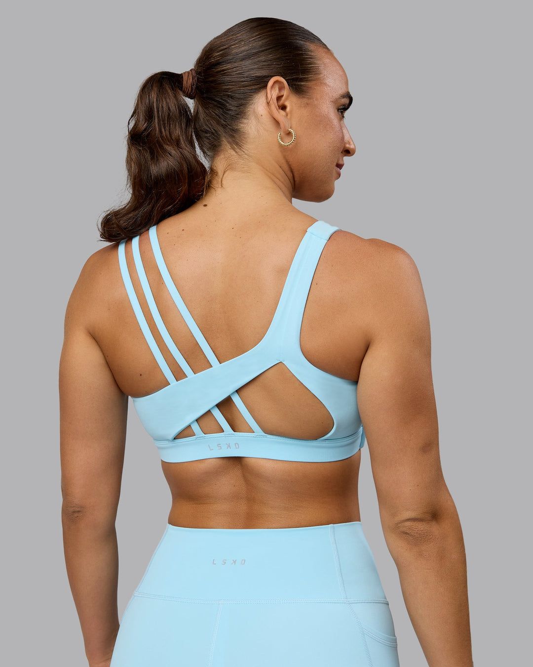 Woman wearing Galvanise Sports Bra - Crystal Blue