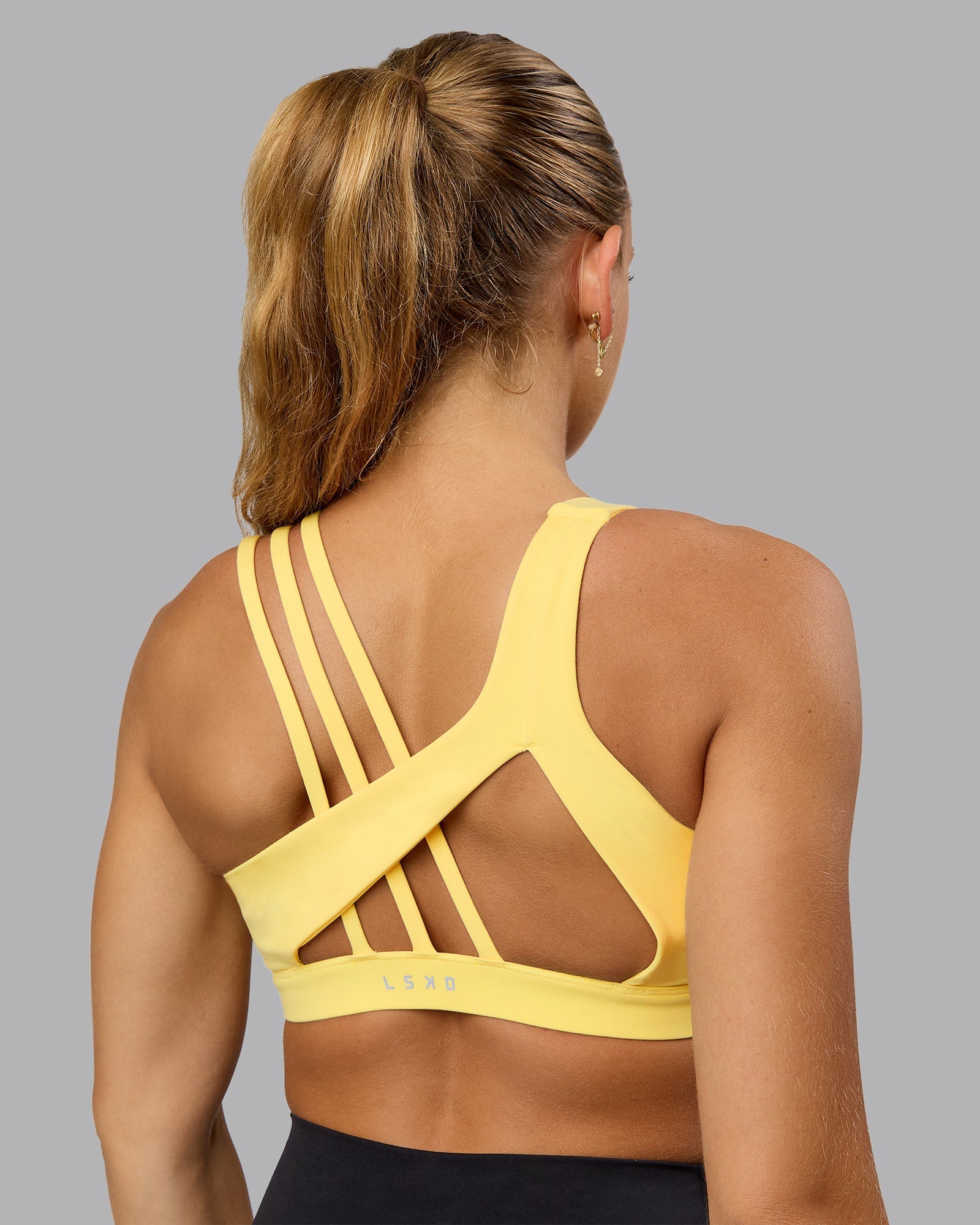 Woman wearing Galvanise Sports Bra - Lemon