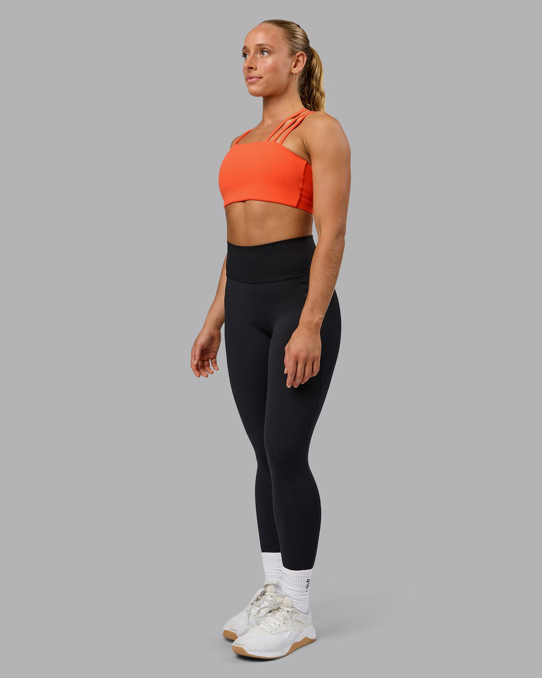 Woman wearing Galvanise Sports Bra - Ultra Orange