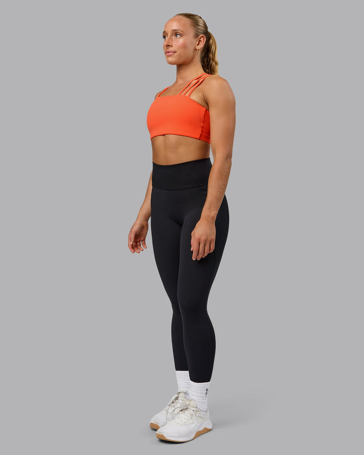 Woman wearing Galvanise Sports Bra - Ultra Orange
