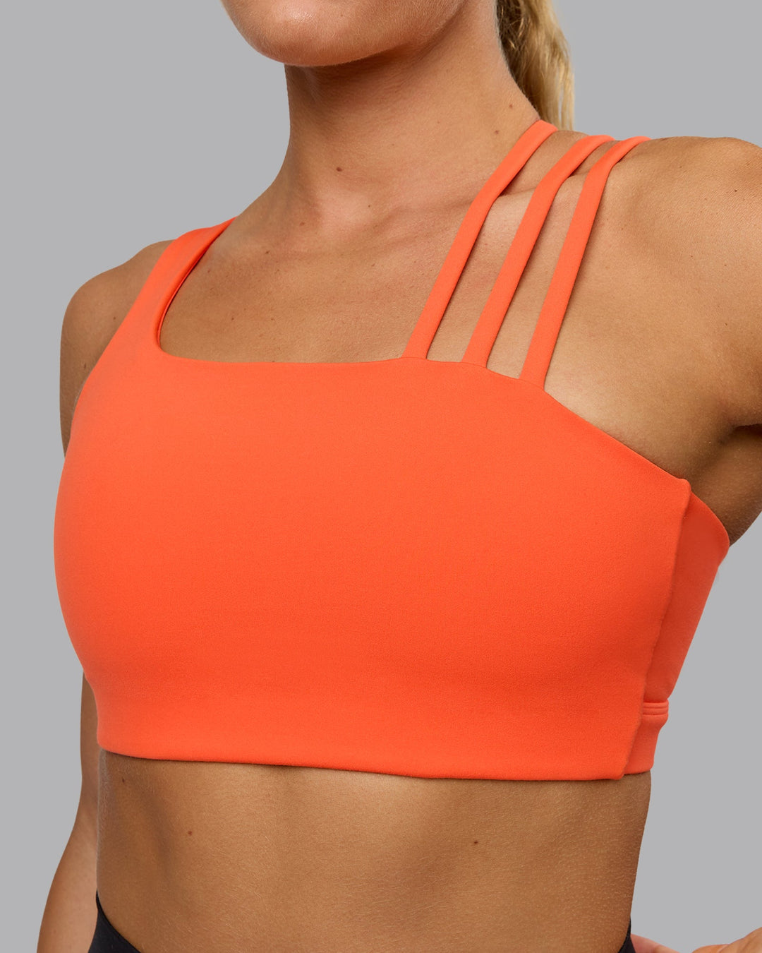 Woman wearing Galvanise Sports Bra - Ultra Orange