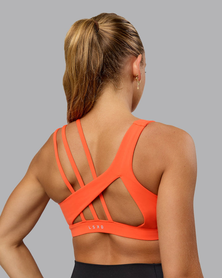 Woman wearing Galvanise Sports Bra - Ultra Orange
