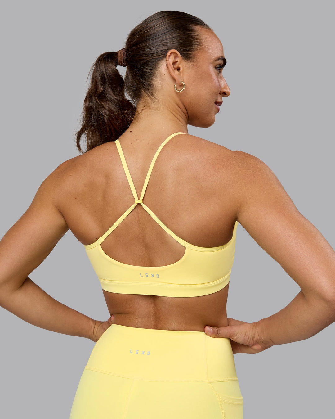 Woman wearing Glow Sports Bra - Lemon