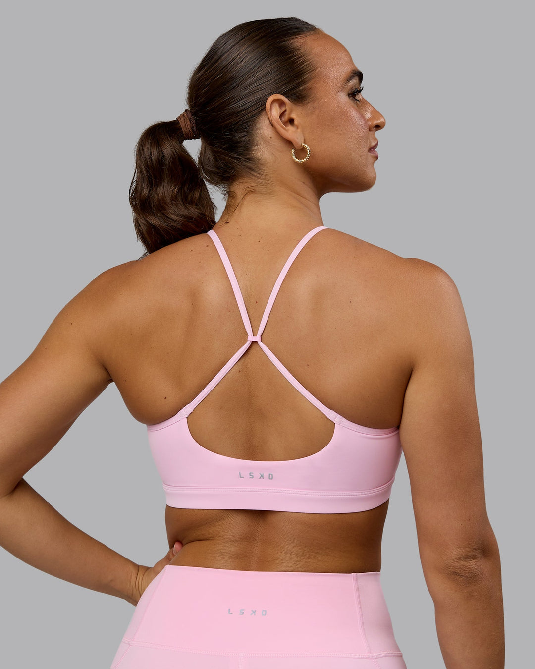 Woman wearing Glow Sports Bra - Pale Pink