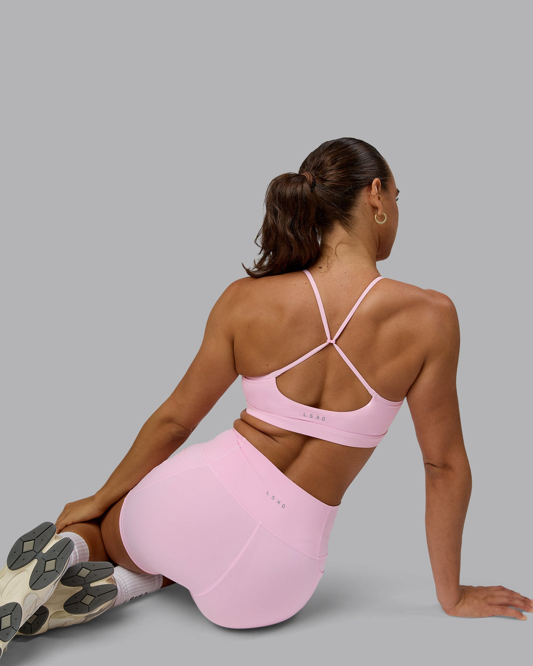 Woman wearing Glow Sports Bra - Pale Pink